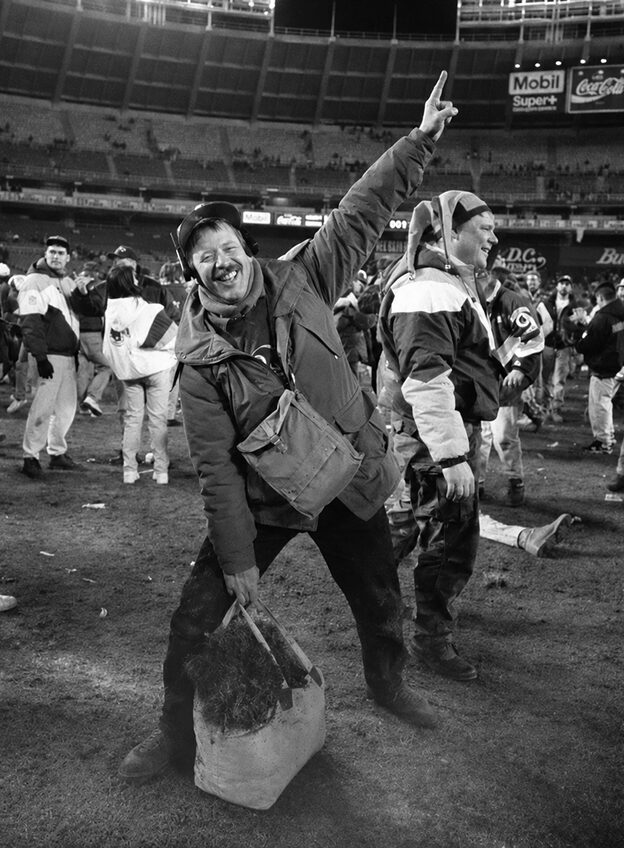 Fans celebrating on the field after a game