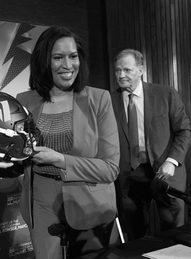 Mayor Muriel Bowser holding a Commanders helmet