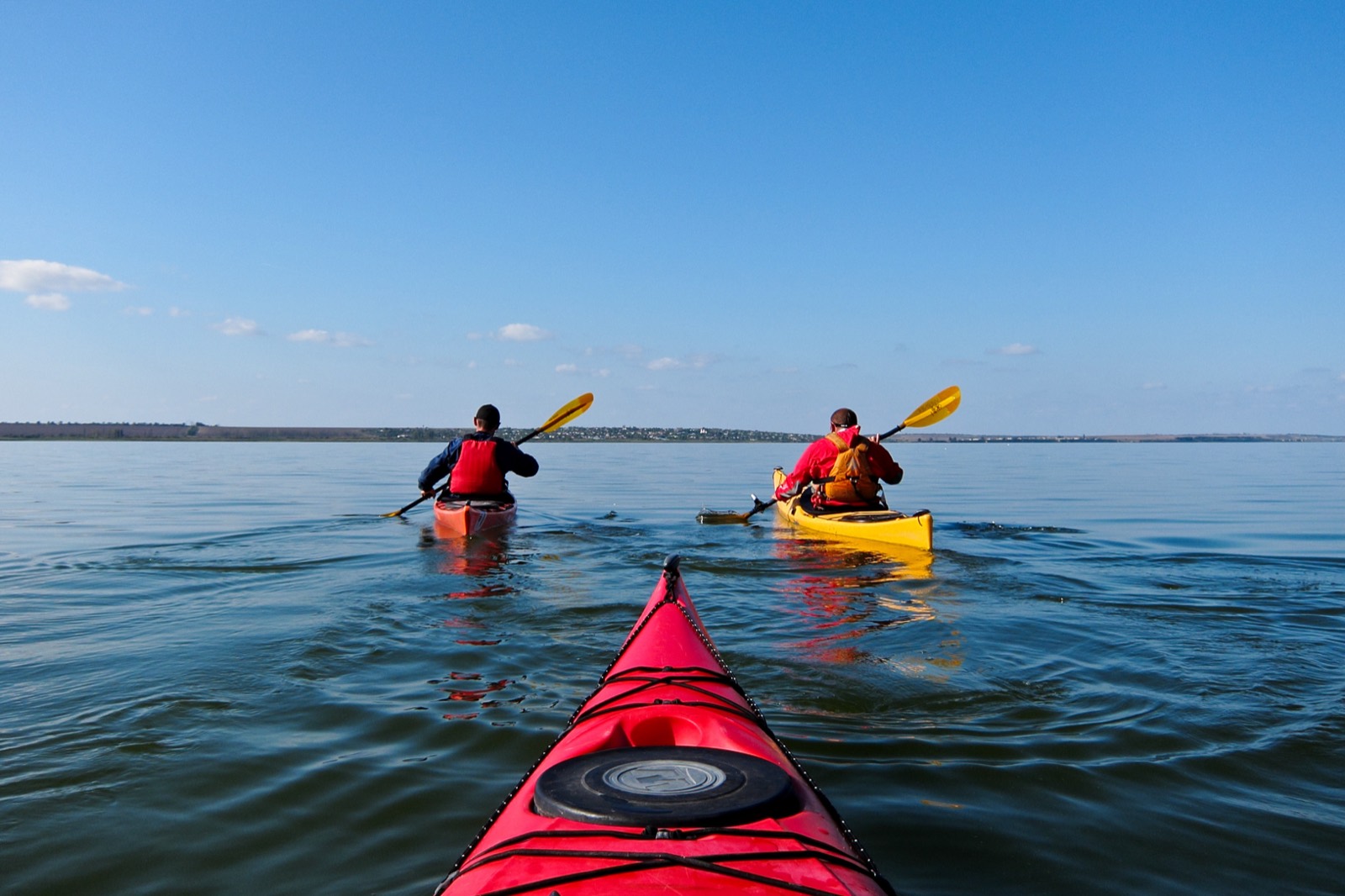 Kayakers paddling on calm water